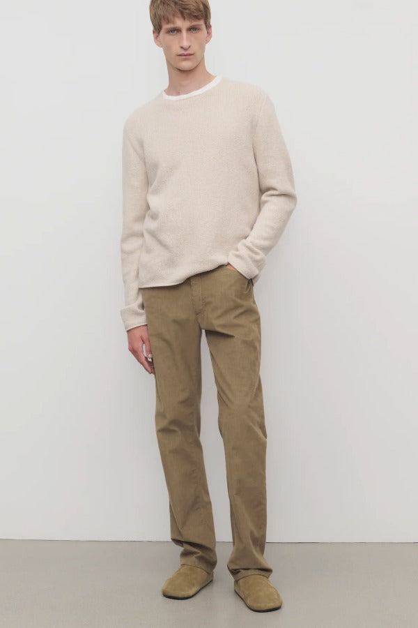 Front view of beige fred pant on model wearing oatmeal top and slides, against a white background.