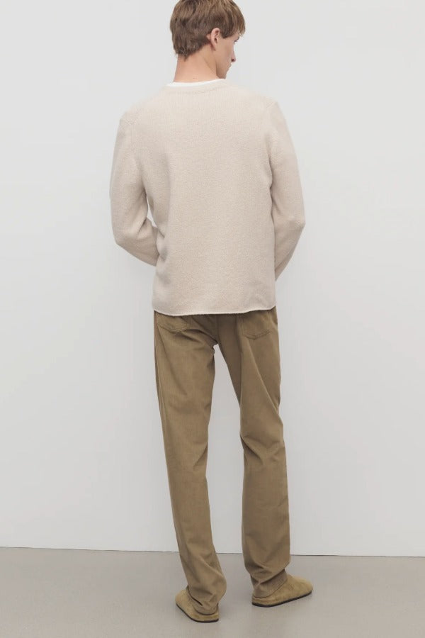 Back view of beige fred pant on model wearing oatmeal top and slides, against a white background.