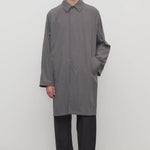 Front view of grey cobalt men's hesper coat on model wearing black pants and boots, against a white background.