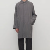 Front view of grey cobalt men's hesper coat on model wearing black pants and boots, against a white background.