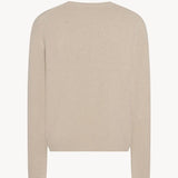 Back view of ecru nikola sweater on white background, with no model shown.