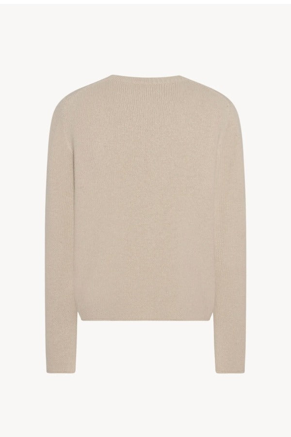 Back view of ecru nikola sweater on white background, with no model shown.