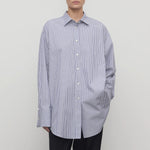 Front view of white and blue Ment shirt on model wearing black trousers, against a white background.