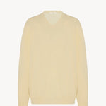 Front view of yellow migeia top on white background, with no model shown. 