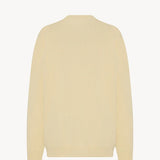 Back view of yellow migeia top on white background, with no model shown.