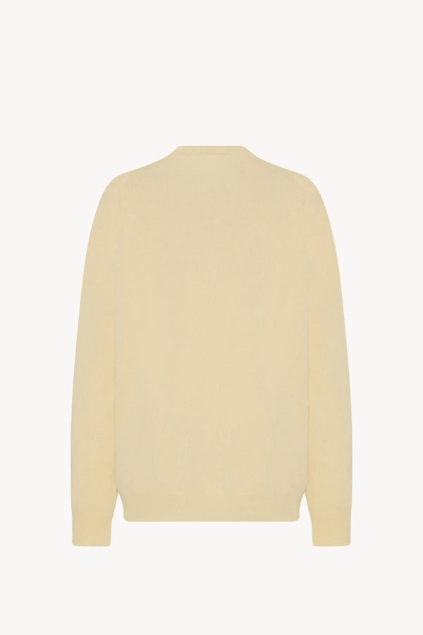 Back view of yellow migeia top on white background, with no model shown.