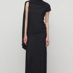 Front view of black mirla skirt on model wearing black top, against a white background.