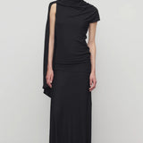 Front view of black mirla skirt on model wearing black top, against a white background.