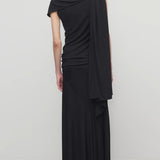 Back view of black mirla skirt on model wearing a black top, against a white background.