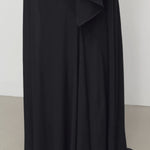 Back closeup view of black mirla skirt on model, against a white background.