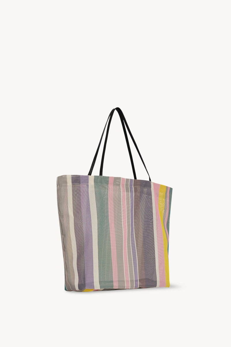 Side slanted view of multi cold mesh and leather bag on white background, with no model shown.