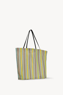 Side slanted view of mesh and leather bag on white background, with no model shown.