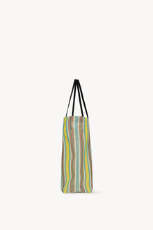 Side view of mesh and leather bag on white background, with no model shown.