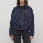 Front view of indigo ness jacket on model wearing black jeans and t-shirt, against a white background
