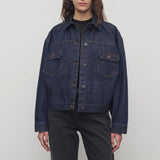 Front view of indigo ness jacket on model wearing black jeans and t-shirt, against a white background