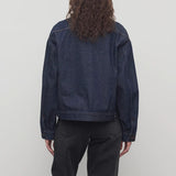 Back view of indigo ness jacket on model wearing black jeans, against a white background.