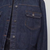 Front closeup view of indigo ness jacket on model wearing black jeans and t-shirt, against a white background.