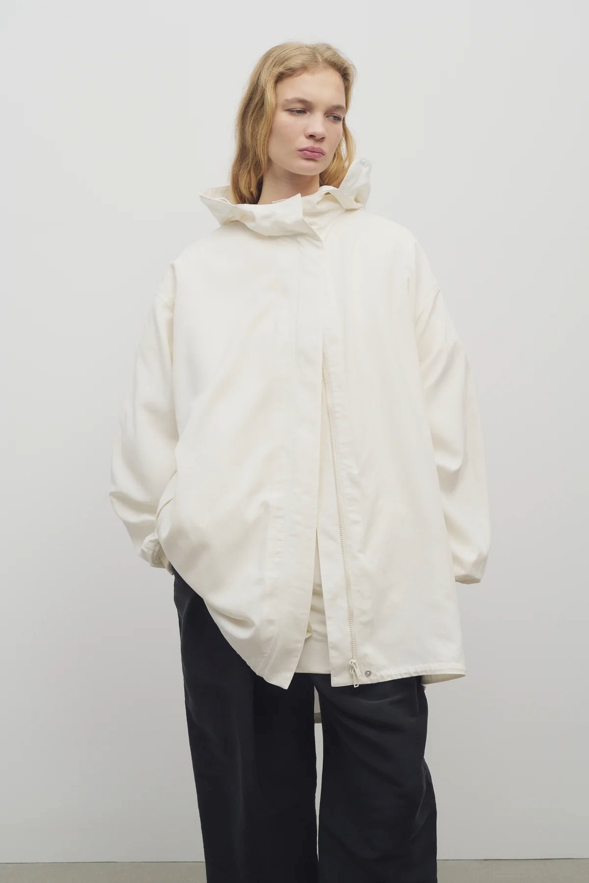 Front view of off-white Kemetina Coat on model wearing black trousers, against white background.