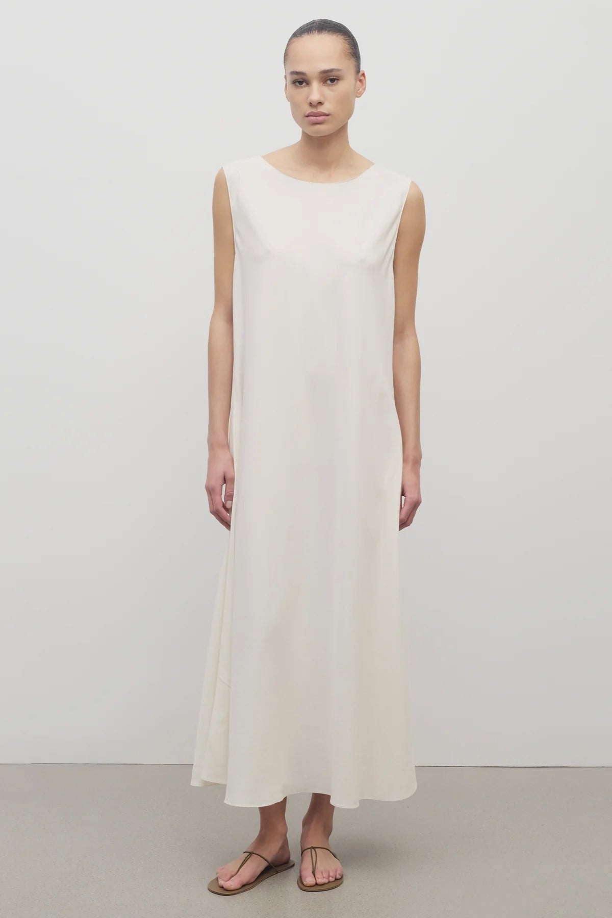 Front view of off-white Nicole dress on white background with model wearing sandals.