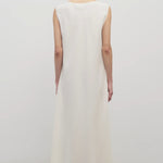 Back view of off-white Nicole dress on model wearing sandals, against a white background.