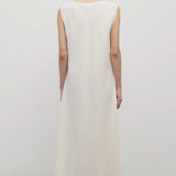 Back view of off-white Nicole dress on model wearing sandals, against a white background.