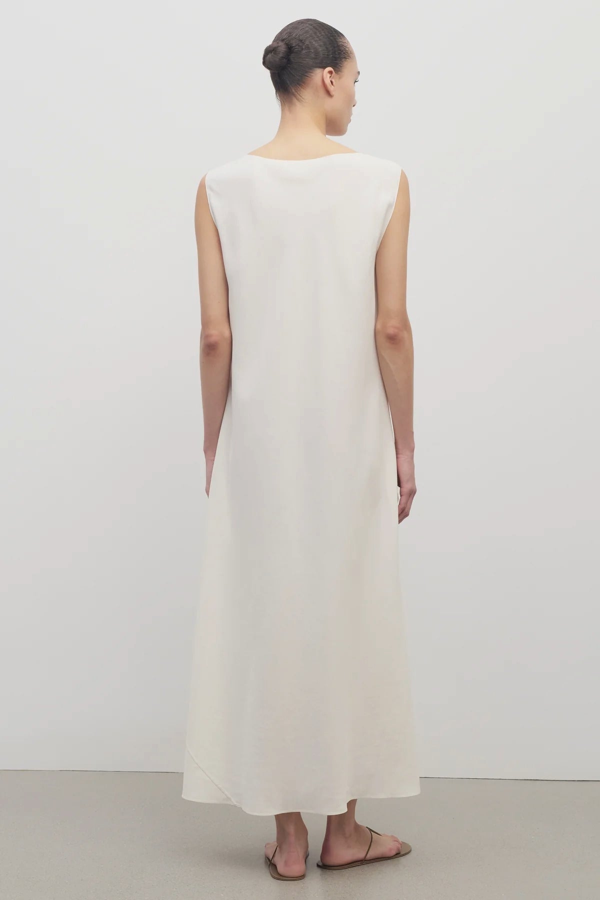 Back view of off-white Nicole dress on model wearing sandals, against a white background.