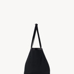 Side view of black park tote three canvas on white background, with no model showm.