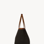 Side view of brown park tote three canvas on white background, with no model shown.