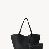 Front view with zip pouch of black park tote three stitch on white background, with no model shown.