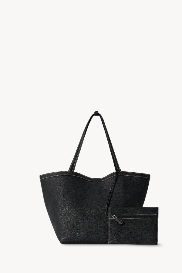 Front view with zip pouch of black park tote three stitch on white background, with no model shown.