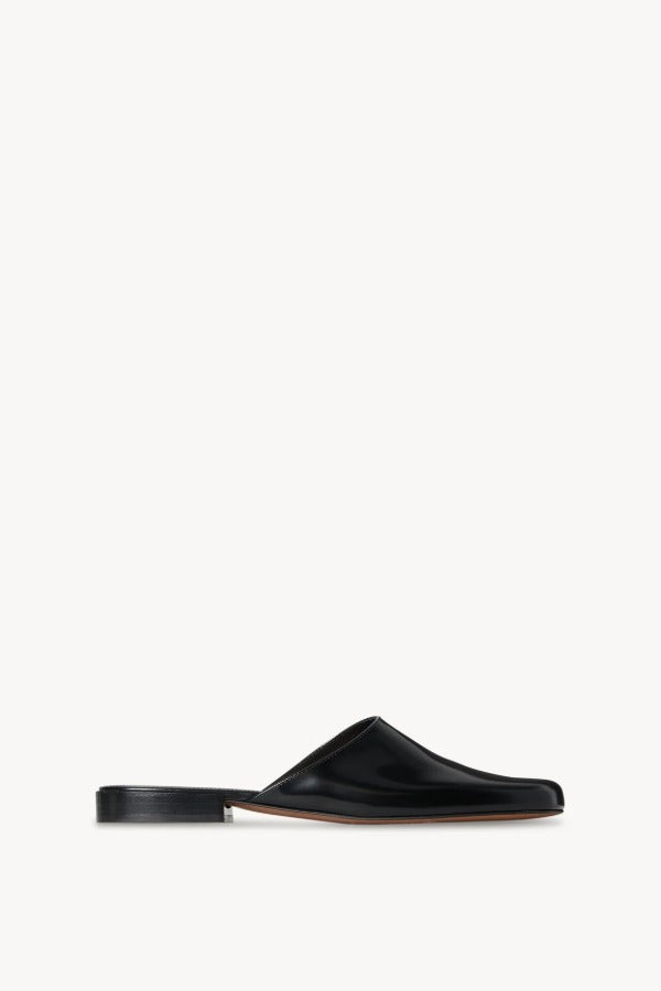 Right side view of black penelope mule on white background, with no model shown.