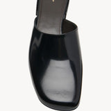 Overhead view of black penelope mule on white background, with no model shown.