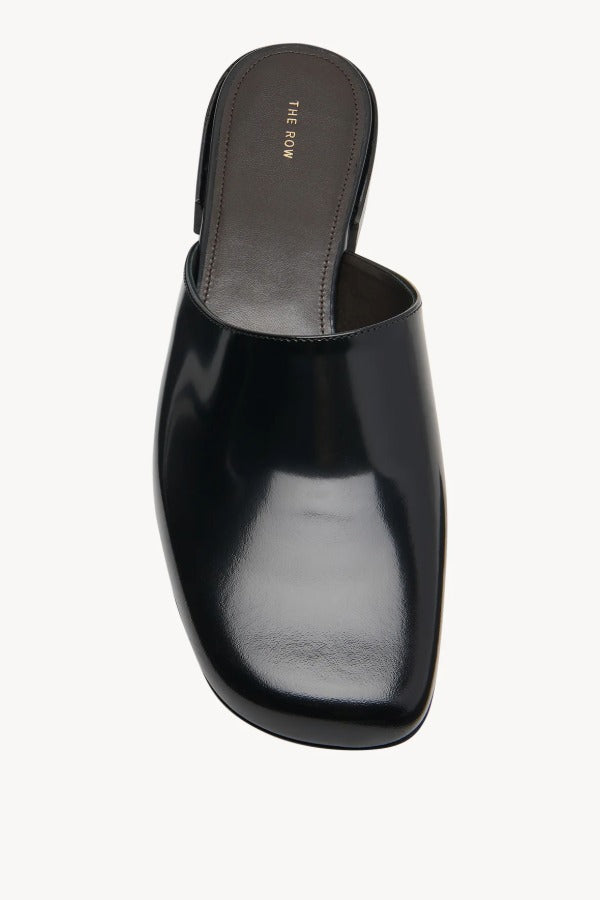 Overhead view of black penelope mule on white background, with no model shown.