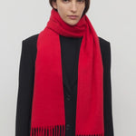 Front view of goji berry perico scarf on model wearing black suit, against a white background.