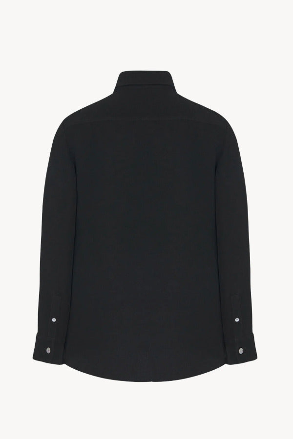 Back view of black petra shirt on white background, with no model shown.