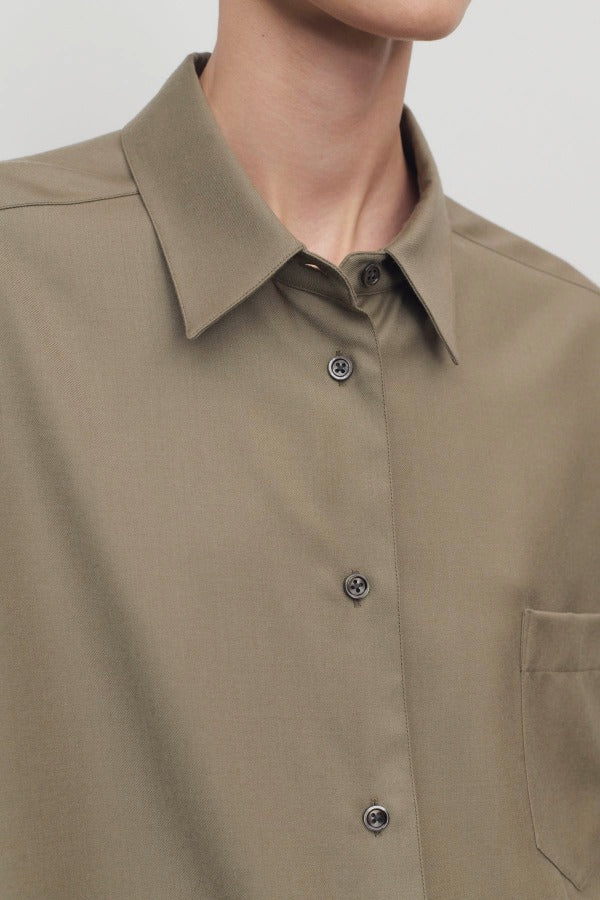 Front view closeup of military beige pino shirt on model, against a white background.