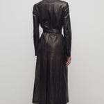 Back view of coffee raisa coat on model wearing low heels, against a white background.