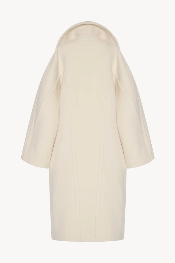 Back view of ivory regino coat on white background, with no model shown.