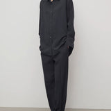Front view of black relian pant on model wearing black shirt and heels, against a white background.
