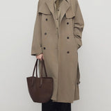 Front view of beige grey rhydian coat on model wearing black pants, against a white background.