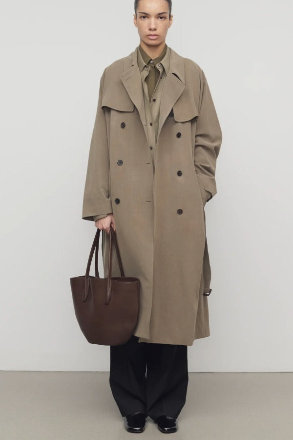 Front view of beige grey rhydian coat on model wearing black pants, against a white background.