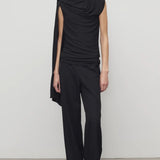 Front view of black roger pant on model wearing black top and heels, against a white background.