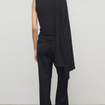 Back view of black roger pant on model wearing black top and heels, against a white background.