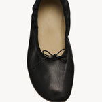 Overhead view of black round ballet flats on white background with no model shown.