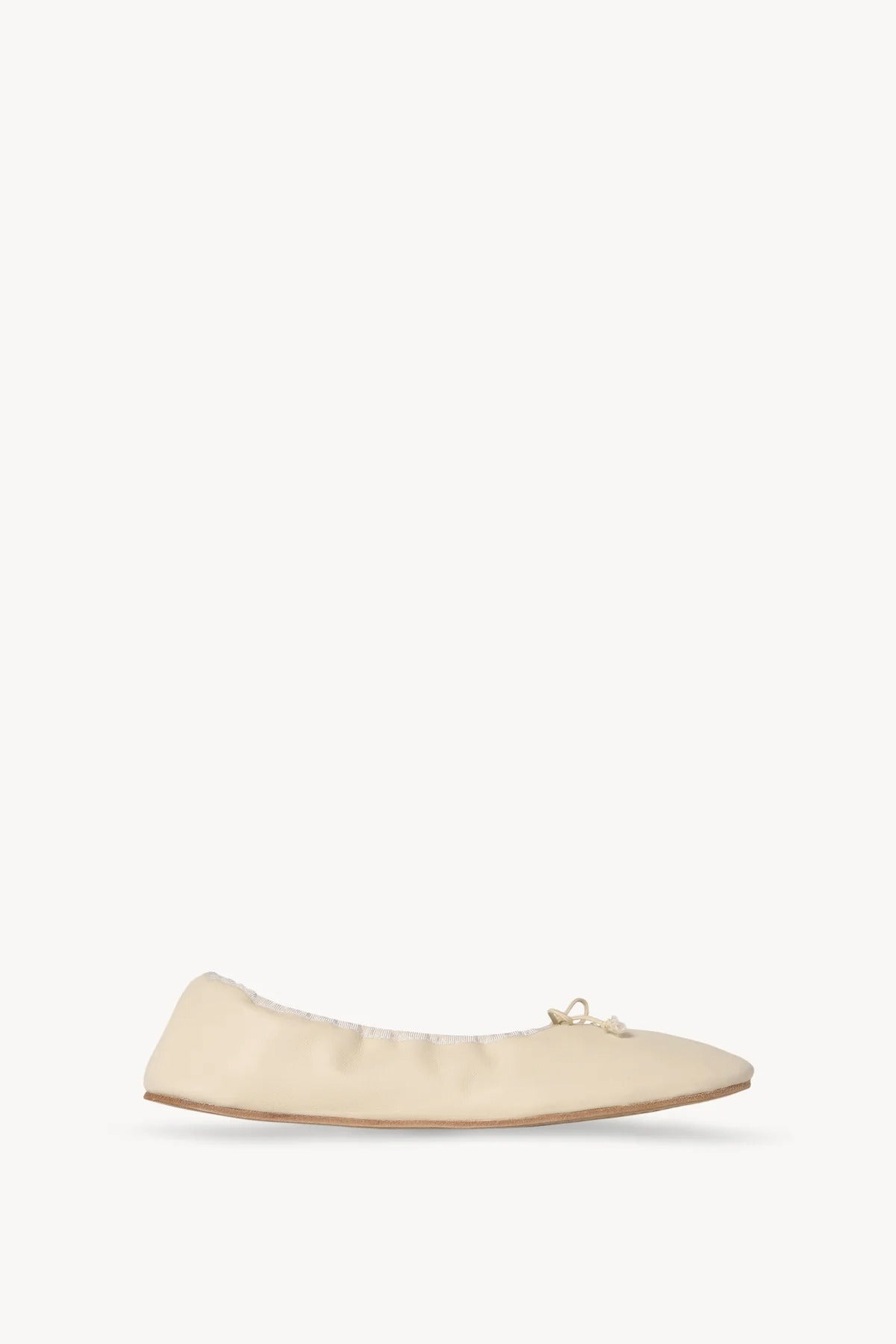 Side view of sage tint round ballet flat on white background, with no model shown.