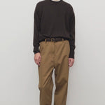 Front view of dark sand sharka pant on model wearing black shirt, against a white background