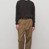 Front view of dark sand sharka pant on model wearing black shirt, against a white background
