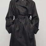Front view of black siempra coat on model, against a white background.