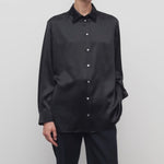 Front view of black sisilia shirt on model wearing black pants, against a white background.