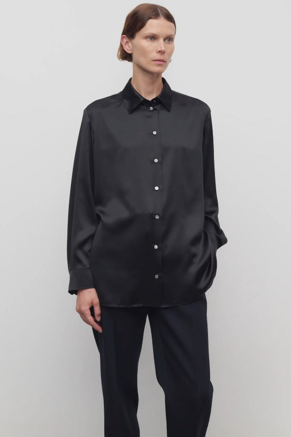 Front view of black sisilia shirt on model wearing black pants, against a white background.